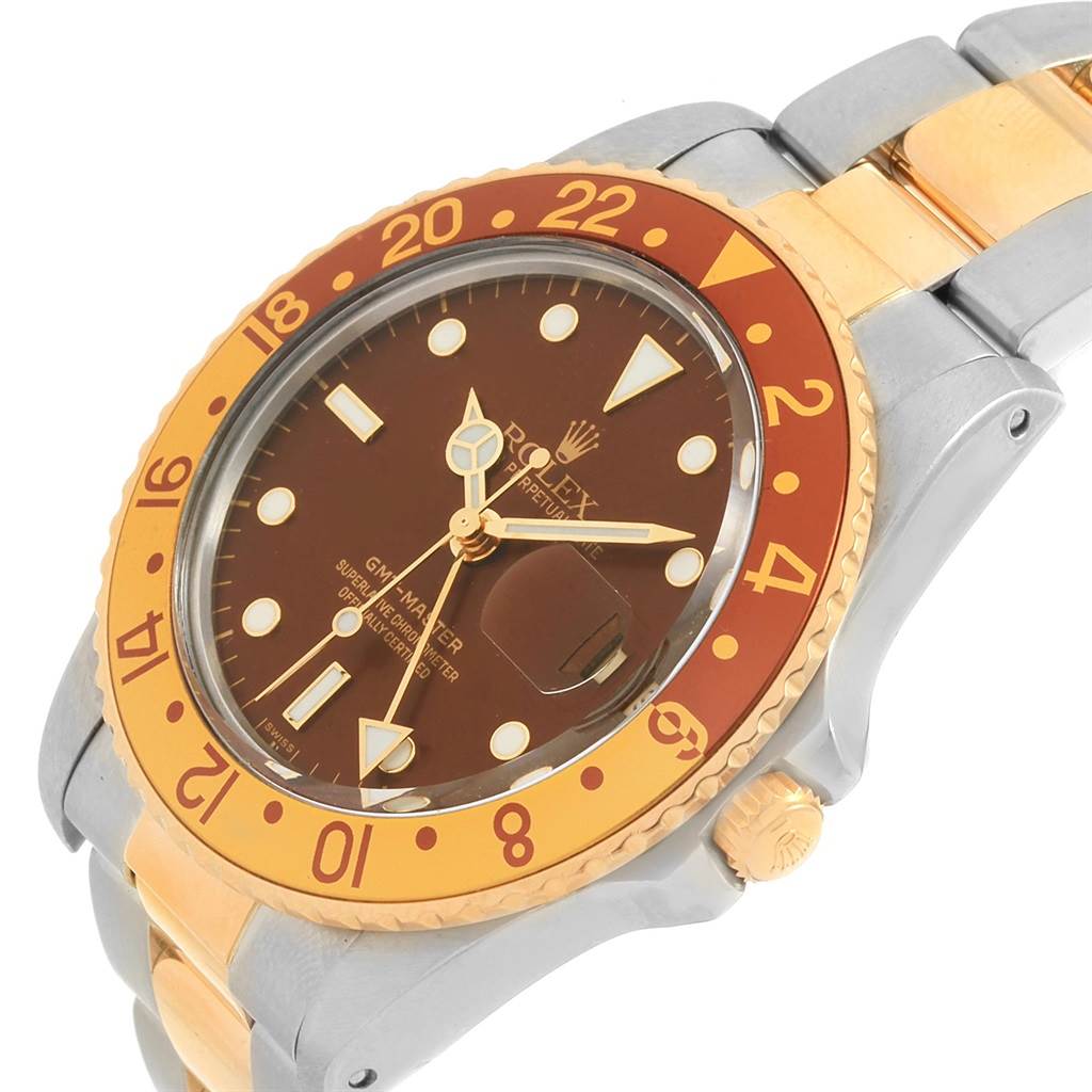 The image shows a close-up angled view of a Rolex GMT-Master 16753 Men's Stainless Steel Brown Dial 16753 Men's Stainless Steel Brown Dial watch, highlighting its brown dial, gold and orange bezel, and part of the bracelet.