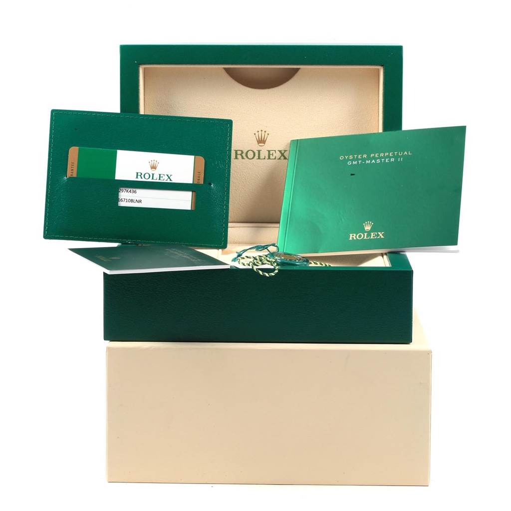 This image shows the packaging, warranty card, and booklet for a Rolex GMT-Master 116710 Men's Stainless Steel Black Dial 116710 Men's Stainless Steel Black Dial II watch.