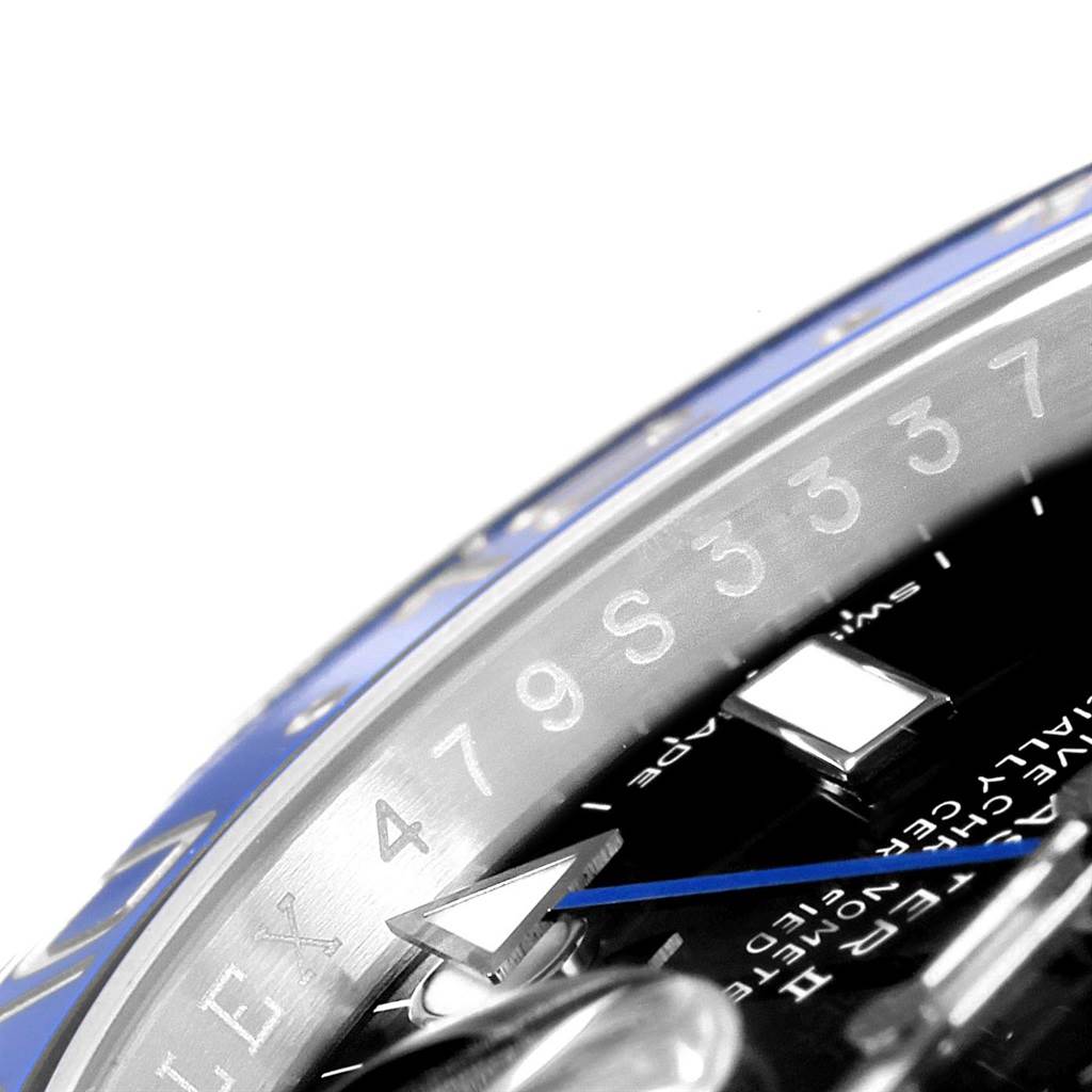 This close-up image shows the bezel, dial, and GMT hand of a Rolex GMT-Master 116710 Men's Stainless Steel Black Dial 116710 Men's Stainless Steel Black Dial watch.