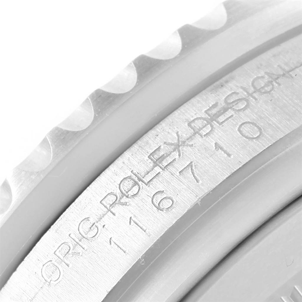 A close-up of the Rolex GMT-Master 116710 Men's Stainless Steel Black Dial 116710 Men's Stainless Steel Black Dial's engraved case edge, showing the serial number and part of the bezel.