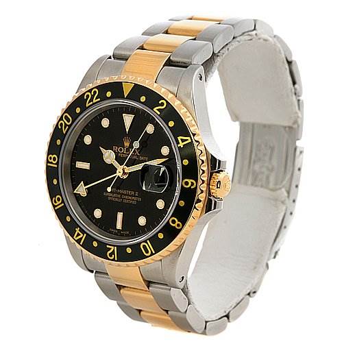 The image shows a side angle of a Rolex GMT-Master 16713 Men's Stainless Steel Black Dial 16713 Men's Stainless Steel Black Dial watch highlighting its black dial, gold and black bezel, and two-tone metal bracelet.