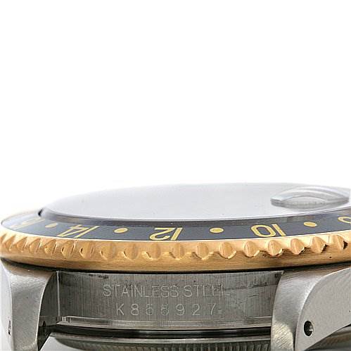 The image shows a close-up of the bezel and case side of a Rolex GMT-Master 16713 Men's Stainless Steel Black Dial 16713 Men's Stainless Steel Black Dial watch, revealing the stainless steel exterior and part of the serial number.