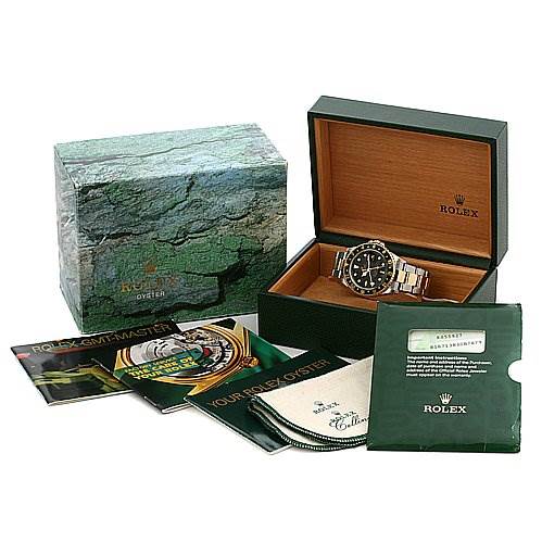 The image shows a Rolex GMT-Master 16713 Men's Stainless Steel Black Dial 16713 Men's Stainless Steel Black Dial watch, its box, manuals, and accessories from an angled top view.