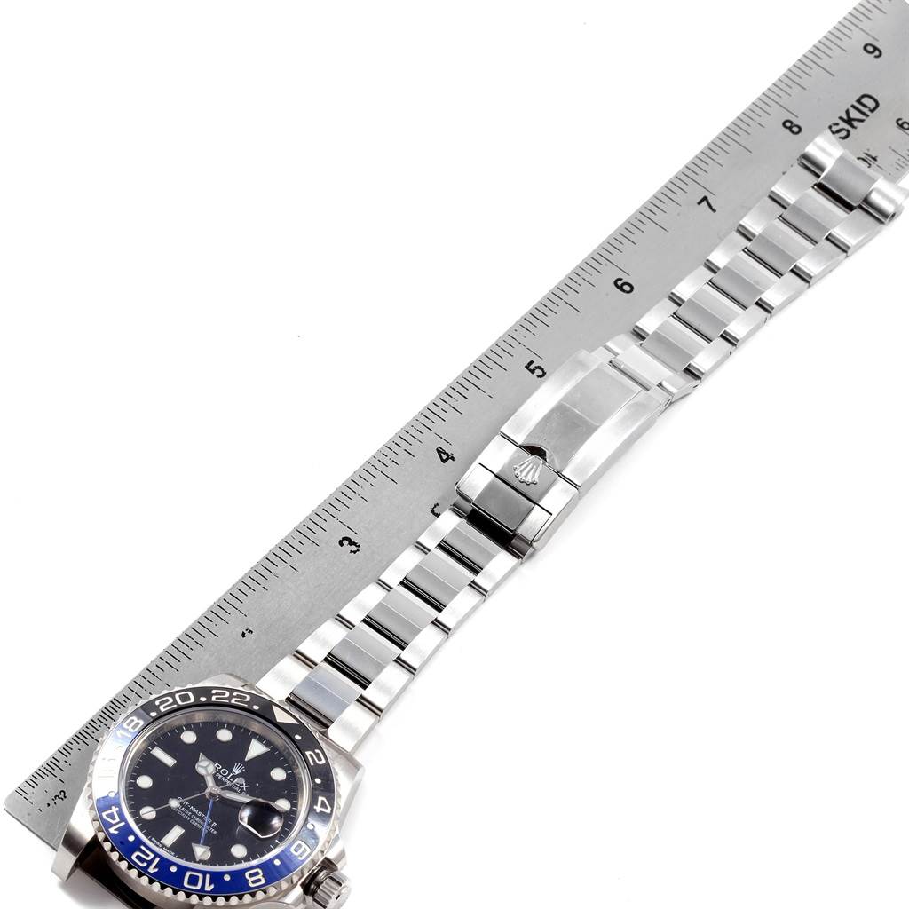 The image shows a Rolex GMT-Master 116710 Men's Stainless Steel Black Dial 116710 Men's Stainless Steel Black Dial watch laid flat next to a ruler, displaying the face and bracelet.