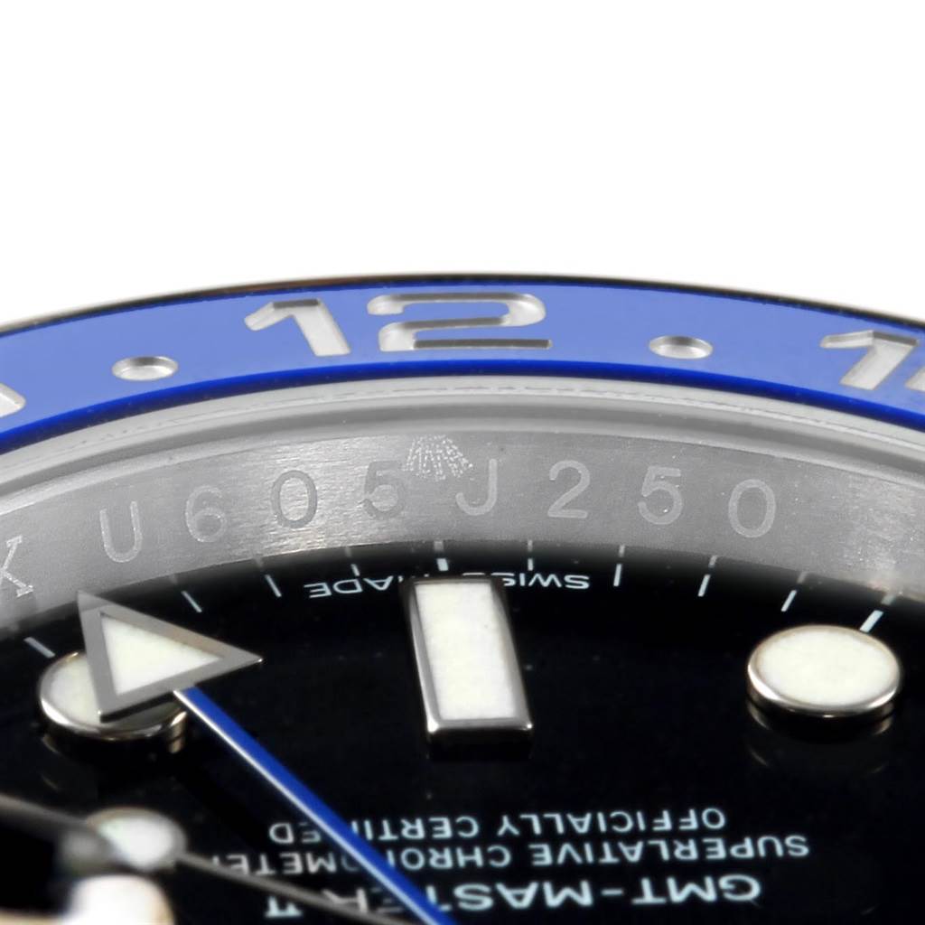 Close-up angle of the Rolex GMT-Master 116710 Men's Stainless Steel Black Dial 116710 Men's Stainless Steel Black Dial watch, showing part of the bezel, dial, and serial number.