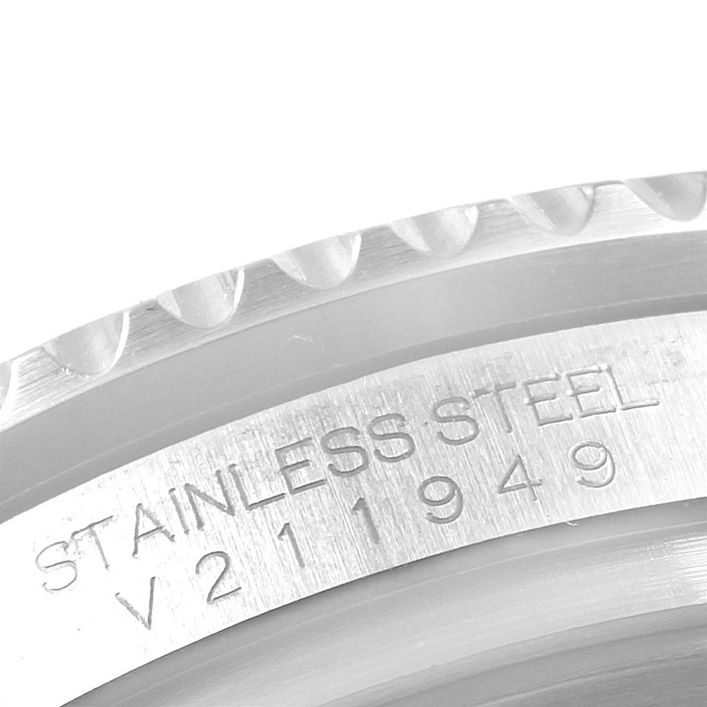 This close-up image of a Rolex GMT-Master 116710 Men's Stainless Steel Black Dial 116710 Men's Stainless Steel Black Dial watch displays the stainless steel casing and the serial number.