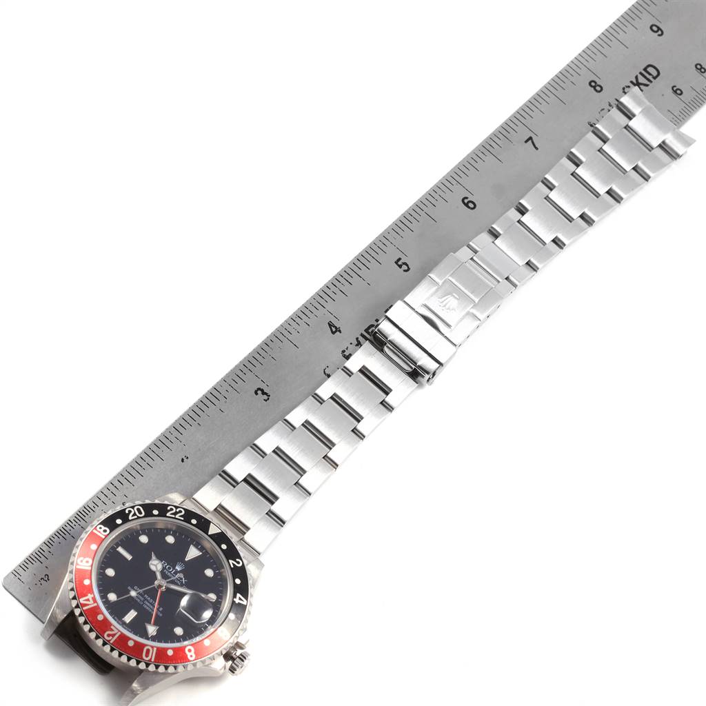 This image shows the Rolex GMT-Master 16710 Men's Stainless Steel Black Dial 16710 Men's Stainless Steel Black Dial watch with its face and bracelet fully visible, alongside a ruler for scale.