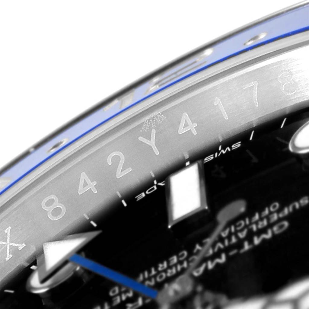 The image shows a close-up angle of the bezel and part of the dial of a Rolex GMT-Master 116710 Men's Stainless Steel Black Dial 116710 Men's Stainless Steel Black Dial watch.