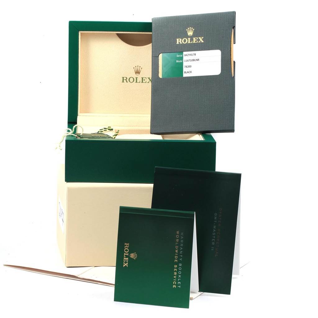 The image shows the packaging and documentation for a Rolex GMT-Master 116710 Men's Stainless Steel Black Dial 116710 Men's Stainless Steel Black Dial, including the box, warranty booklet, and model information.