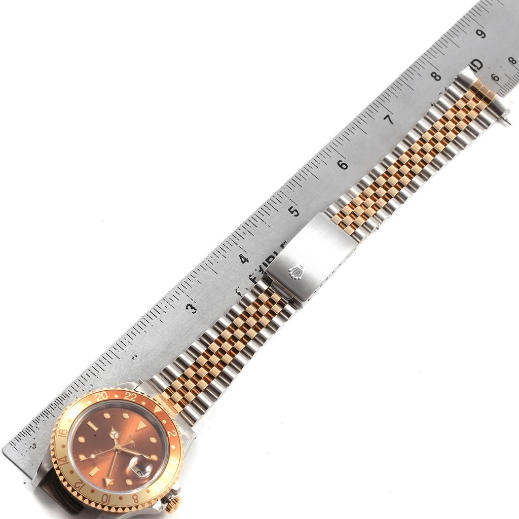This image shows a Rolex GMT-Master 16713 Men's Stainless Steel Brown Dial 16713 Men's Stainless Steel Brown Dial watch laid flat next to a ruler, displaying the watch band and face.