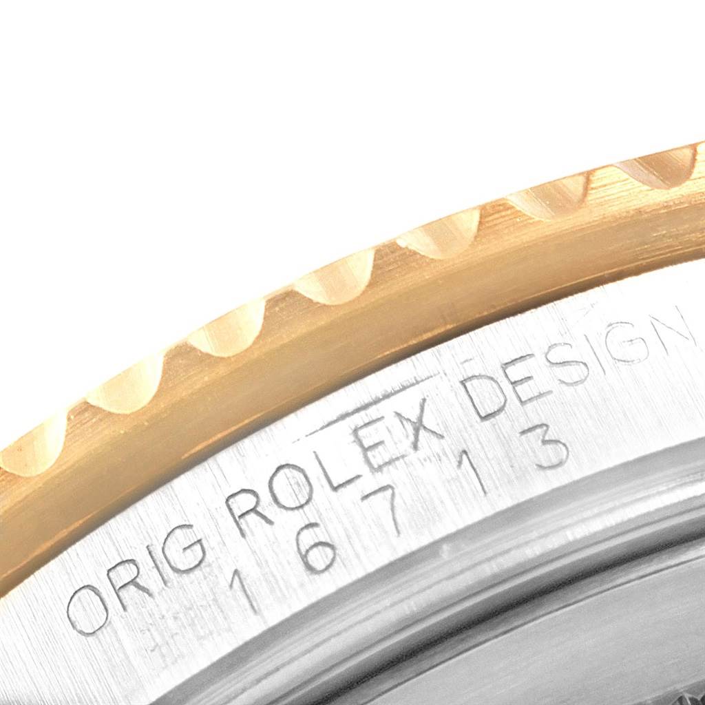 A close-up view of the Rolex GMT-Master 16713 Men's Stainless Steel Brown Dial 16713 Men's Stainless Steel Brown Dial model shows the edge of the bezel and case with the engraved serial number "16713".