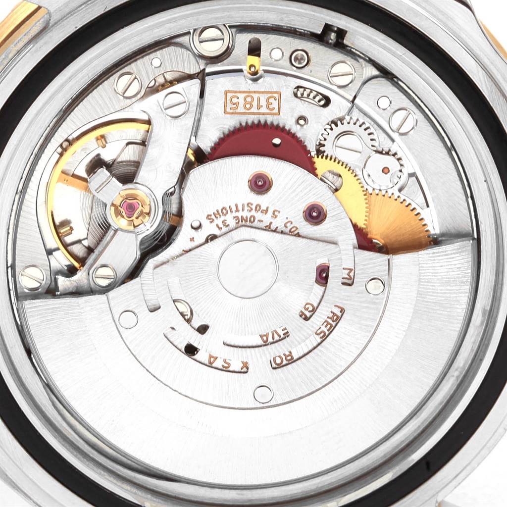 The image shows the inner mechanical movement of the Rolex GMT-Master 16713 Men's Stainless Steel Brown Dial 16713 Men's Stainless Steel Brown Dial watch, angled to display its intricate components.