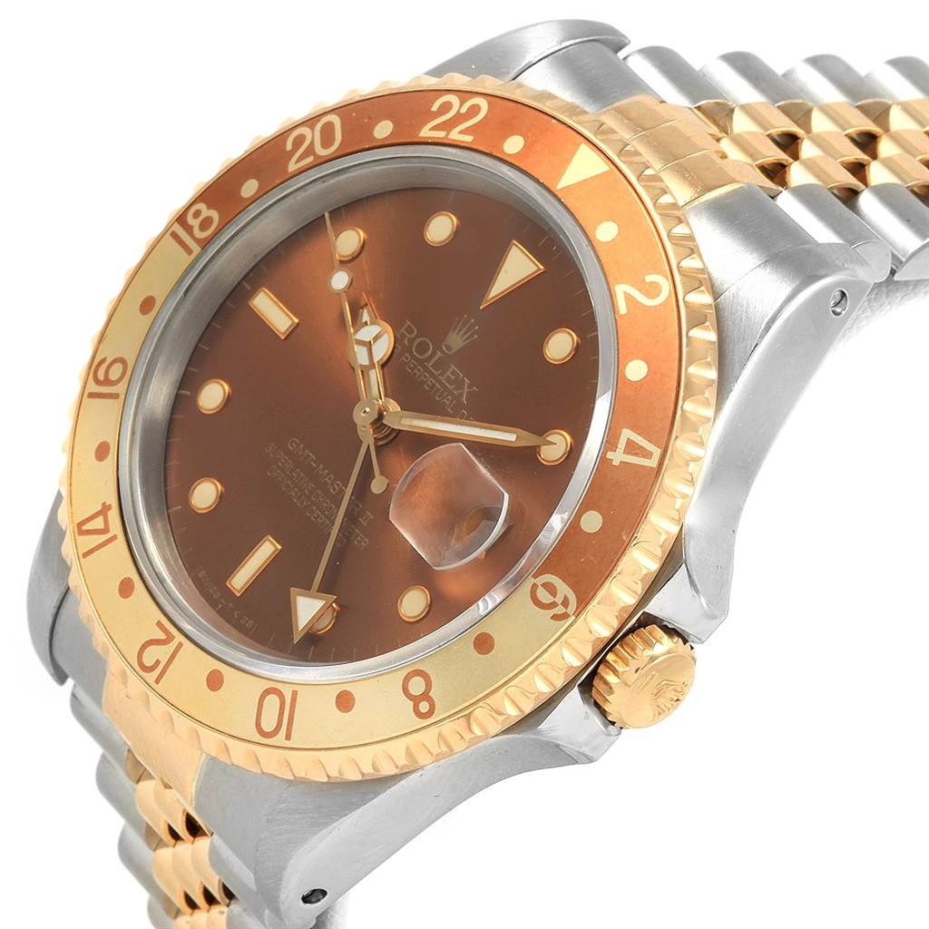 The Rolex GMT-Master 16713 Men's Stainless Steel Brown Dial 16713 Men's Stainless Steel Brown Dial watch is shown from an angled side view displaying its brown dial, gold bezel, crown, and part of the bracelet.