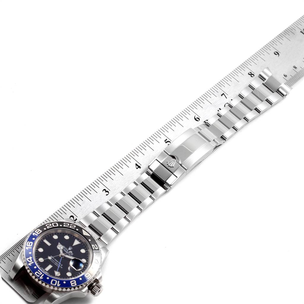 The image shows a Rolex GMT-Master 116710 Men's Stainless Steel Black Dial 116710 Men's Stainless Steel Black Dial watch lying flat with a ruler next to it, displaying the face, bezel, and bracelet.