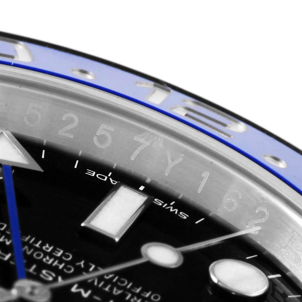 The image shows a close-up angle of the Rolex GMT-Master 116710 Men's Stainless Steel Black Dial 116710 Men's Stainless Steel Black Dial's bezel, dial, and hands.