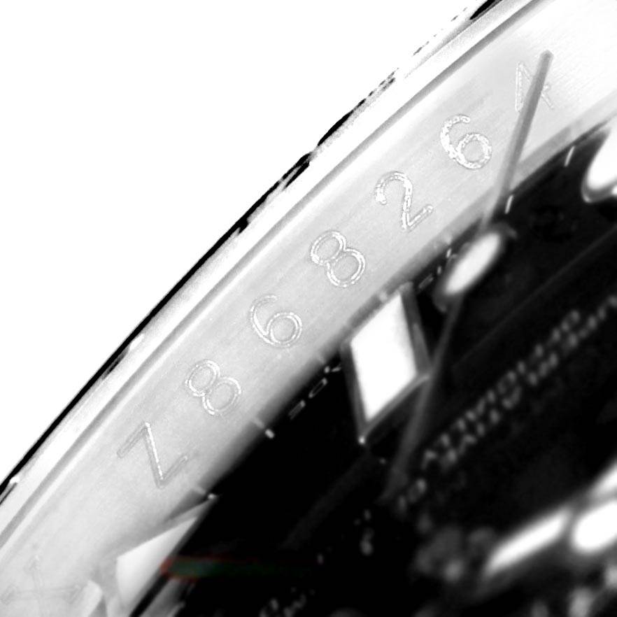 The image shows a close-up of the serial number engraved on the case of a Rolex GMT-Master 116710 Men's Stainless Steel Black Dial 116710 Men's Stainless Steel Black Dial watch.