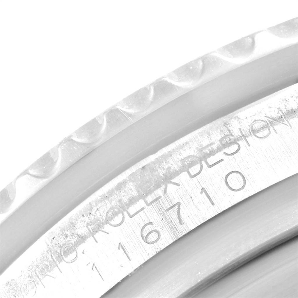 This close-up image of the Rolex GMT-Master 116710 Men's Stainless Steel Black Dial 116710 Men's Stainless Steel Black Dial watch showcases the engraved serial number on the case.