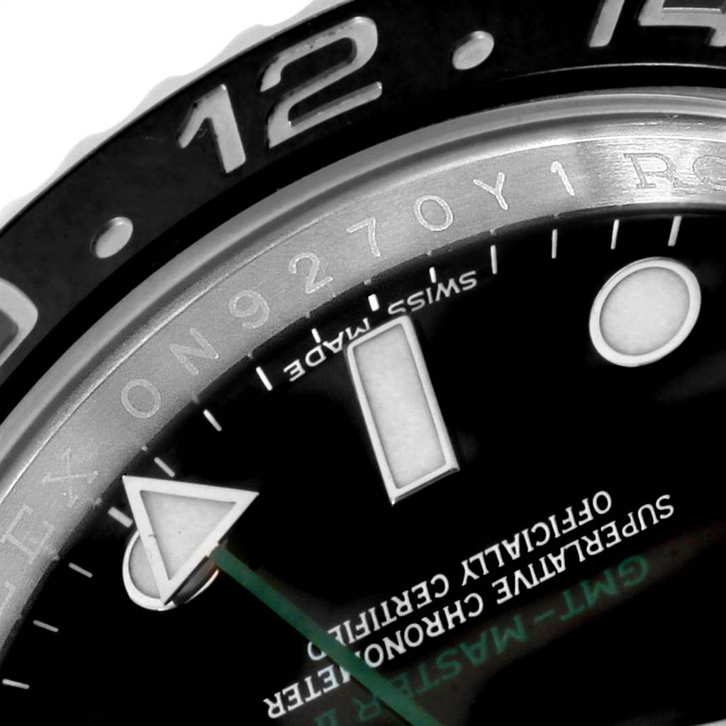 This close-up of a Rolex GMT-Master 116710 Men's Stainless Steel Black Dial 116710 Men's Stainless Steel Black Dial watch shows the bezel, part of the dial, and the hands.