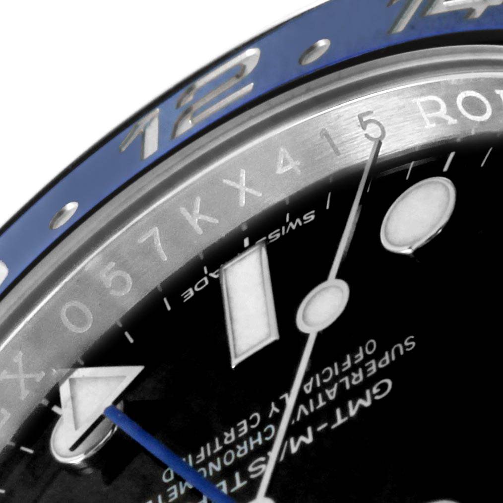 This close-up image of the Rolex GMT-Master 116710 Men's Stainless Steel Black Dial 116710 Men's Stainless Steel Black Dial watch displays the bezel, part of the dial, and some hands.