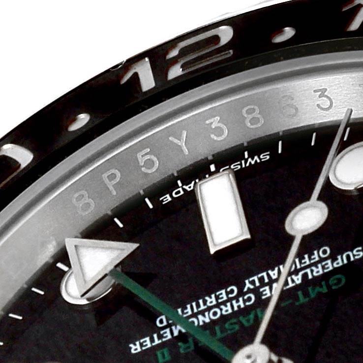 The image shows a close-up angle of the Rolex GMT-Master 116710 Men's Stainless Steel Black Dial 116710 Men's Stainless Steel Black Dial bezel, dial, and part of the hour markers.