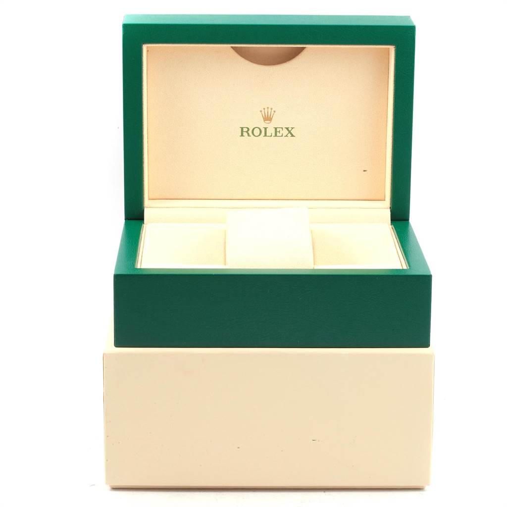 The image shows an open Rolex box in green and beige, likely for a GMT-Master model watch, taken from a front angle.