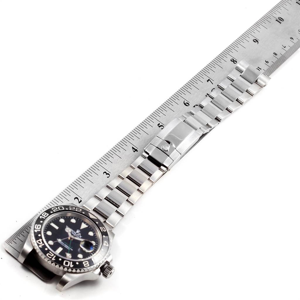 The image shows a top-down view of a Rolex GMT-Master 116710 Men's Stainless Steel Black Dial 116710 Men's Stainless Steel Black Dial watch, focusing on the dial, bezel, bracelet, and clasp, placed next to a ruler.