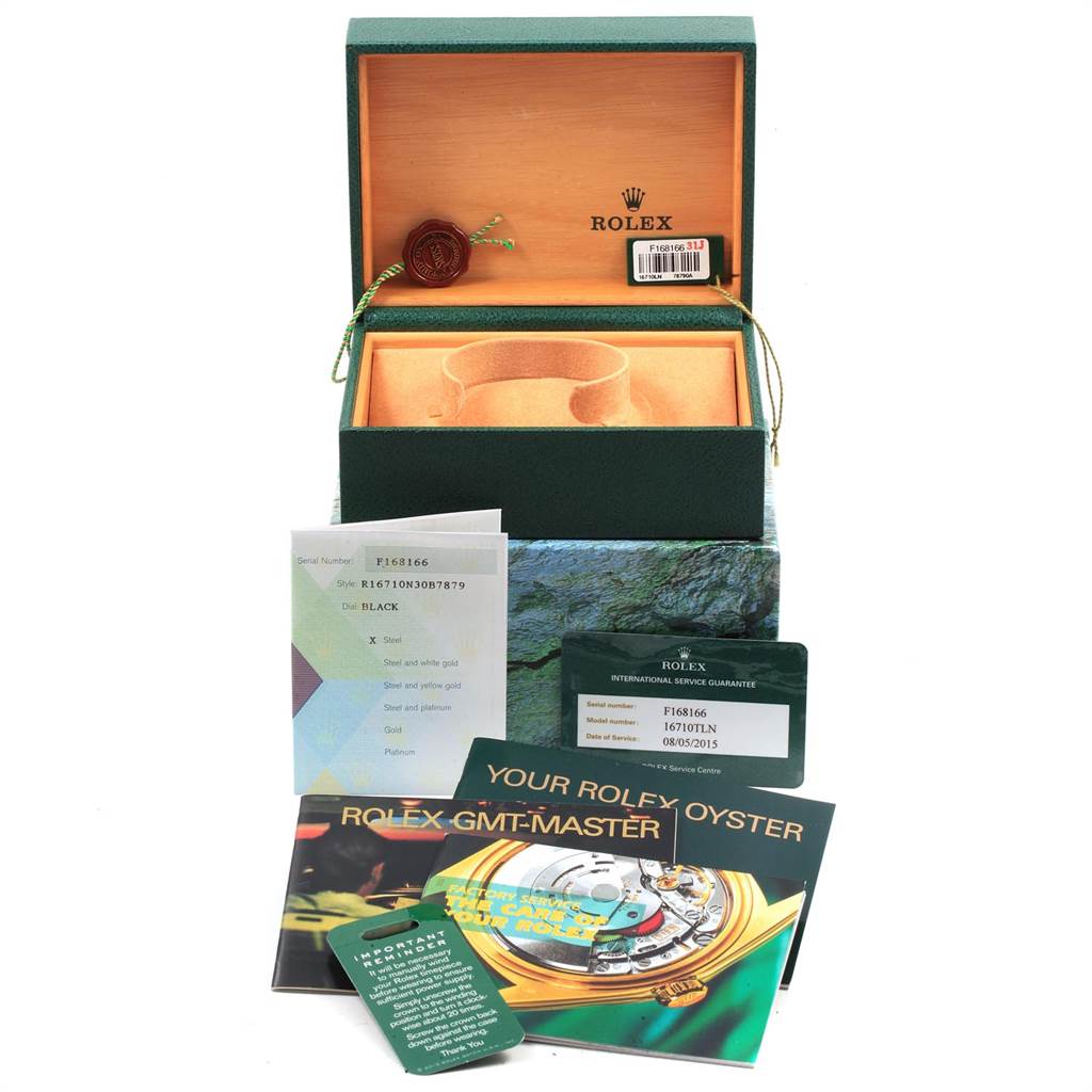 This image showcases the accessories and packaging for a Rolex GMT-Master 16710 Men's Stainless Steel Black Dial 16710 Men's Stainless Steel Black Dial, including the box, booklets, tags, and guarantee card.