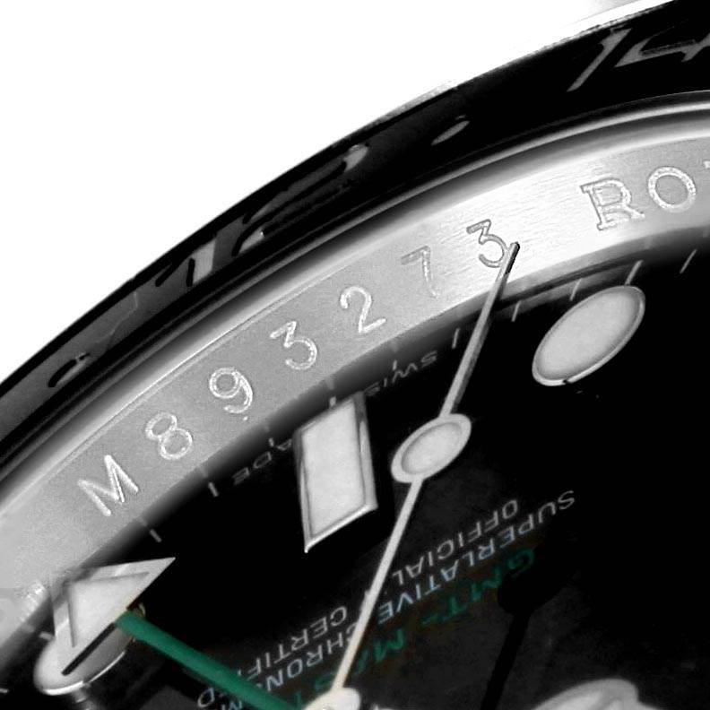 The image shows a close-up angle of the Rolex GMT-Master 116710 Men's Stainless Steel Black Dial 116710 Men's Stainless Steel Black Dial watch, highlighting the serial number and part of the dial.