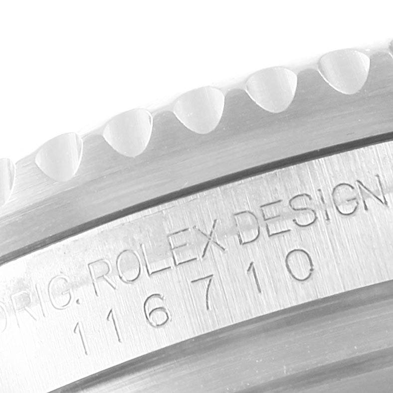 This image shows a close-up of the Rolex GMT-Master 116710 Men's Stainless Steel Black Dial 116710 Men's Stainless Steel Black Dial model's serrated bezel and engraved case serial number.