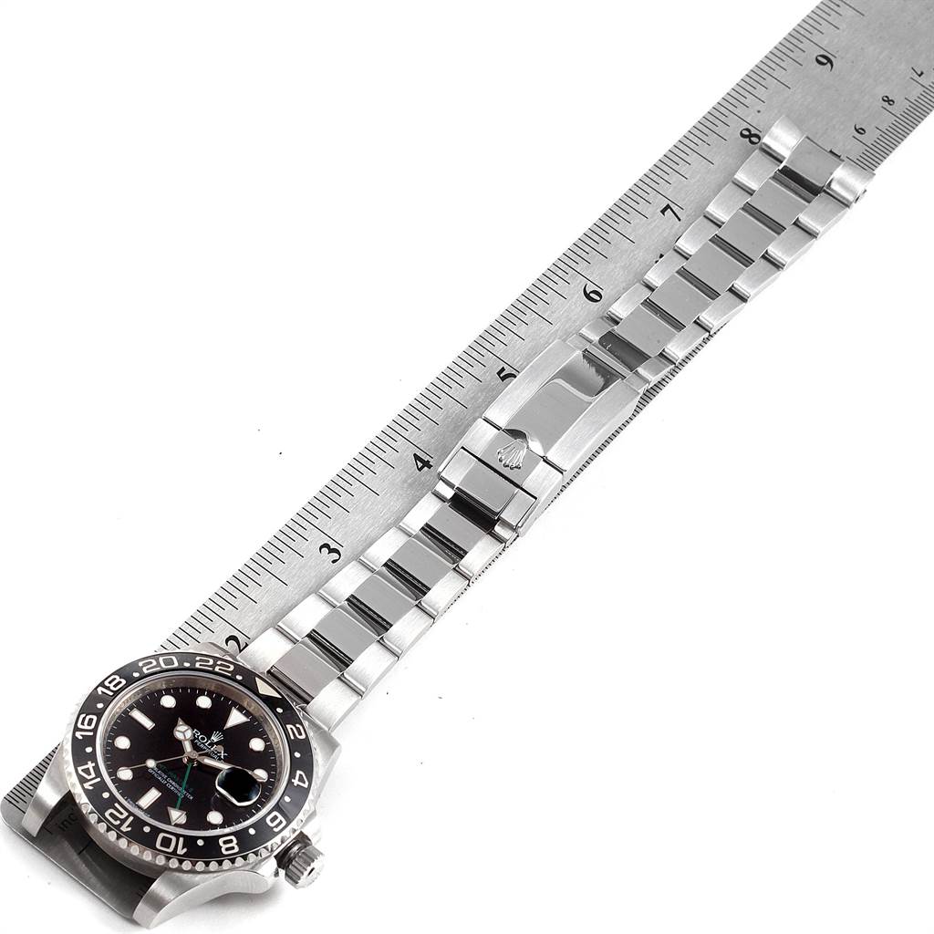 The image shows a Rolex GMT-Master 116710 Men's Stainless Steel Black Dial 116710 Men's Stainless Steel Black Dial watch, focusing on the dial, bezel, bracelet, and clasp, with a ruler for scale.