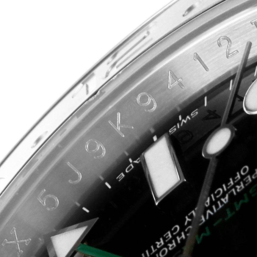 The image shows a close-up of the bezel, chapter ring, and part of the dial of a Rolex GMT-Master 116710 Men's Stainless Steel Black Dial 116710 Men's Stainless Steel Black Dial watch.