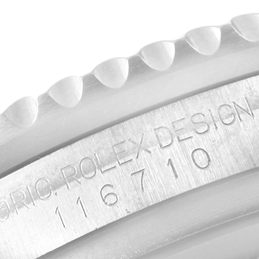 This image shows a close-up of the Rolex GMT-Master 116710 Men's Stainless Steel Black Dial 116710 Men's Stainless Steel Black Dial's bezel edge and engraved design number on the case.