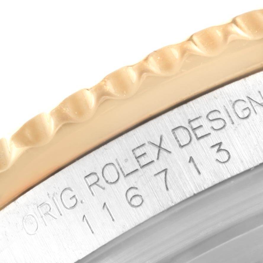 Close-up of the engraved serial number and fluted bezel on a Rolex GMT-Master 116713 Men's Stainless Steel Black Dial 116713 Men's Stainless Steel Black Dial watch.