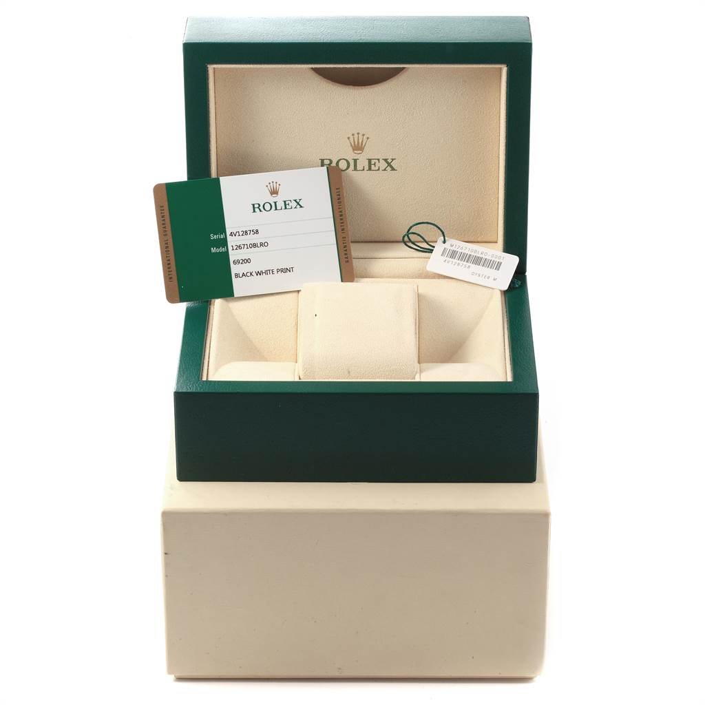 The image shows the open box of a Rolex GMT-Master 126710 Men's Stainless Steel Black Dial 126710 Men's Stainless Steel Black Dial watch, including its guarantee card and accessory tags.