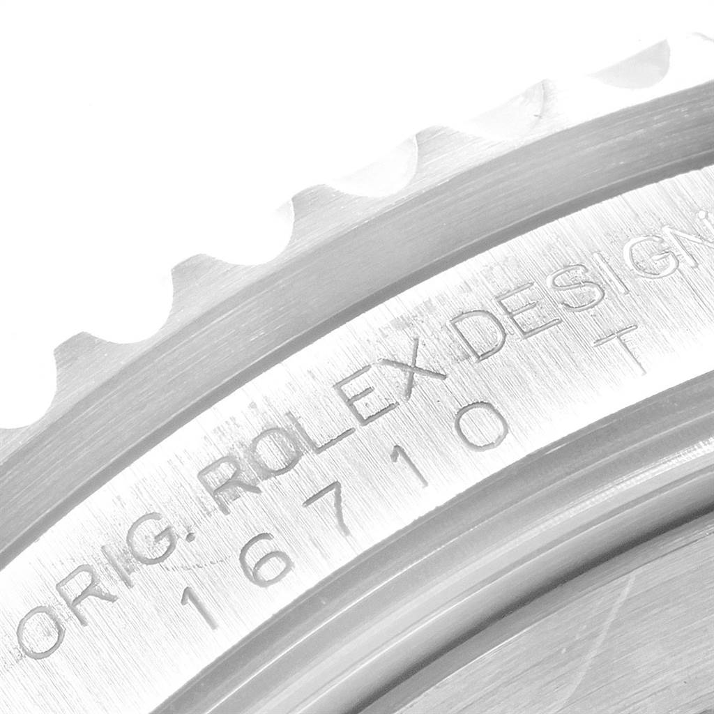 This close-up image shows the engraved model number and part of the bezel of a Rolex GMT-Master 16710 Men
s Stainless Steel Black Dial 16710 Men
s Stainless Steel Black Dial watch.