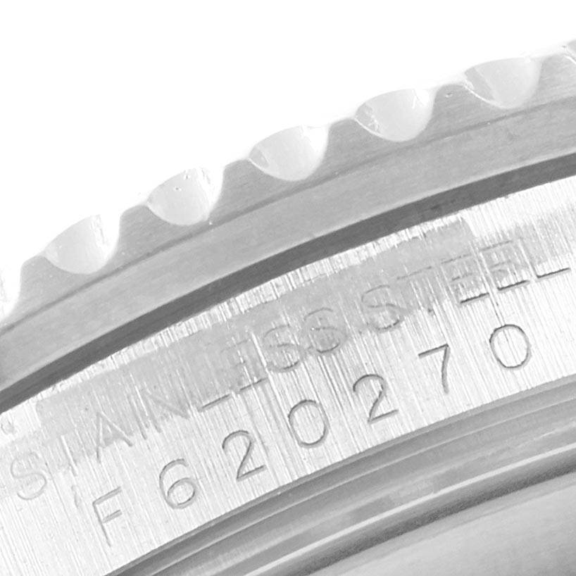 The image shows a close-up of the caseback and part of the bezel of a Rolex GMT-Master 16710 Men
s Stainless Steel Black Dial 16710 Men
s Stainless Steel Black Dial watch, highlighting the model
s serial number.