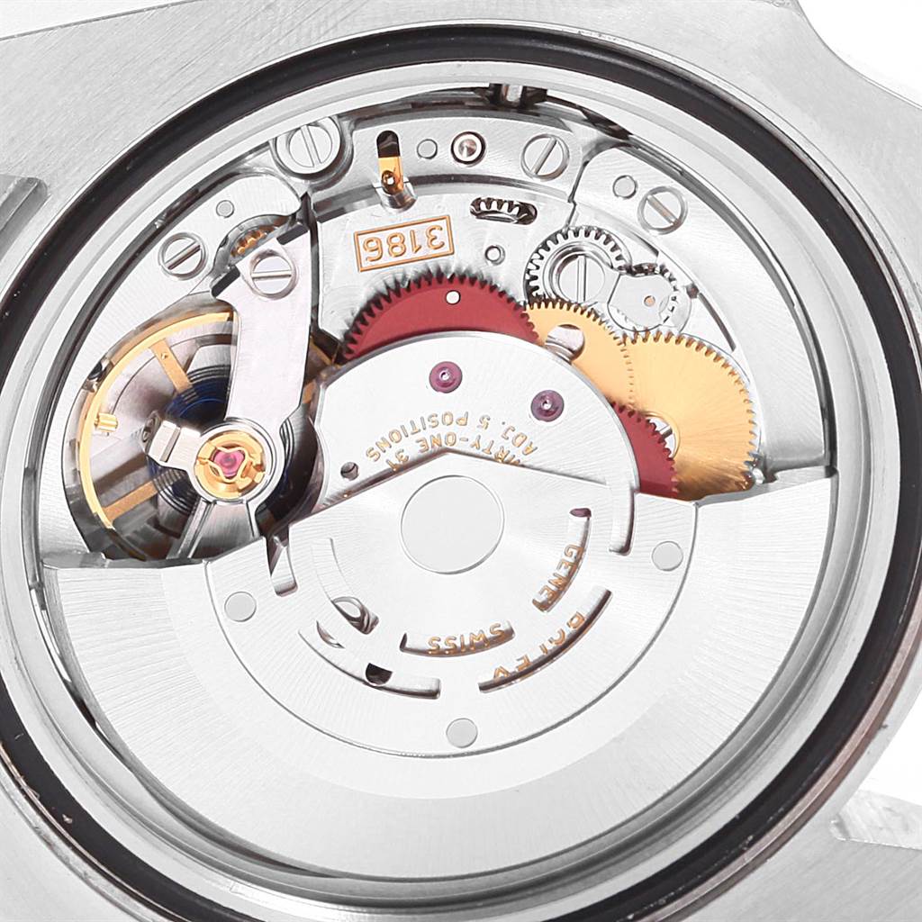 This image shows a close-up view of the inner mechanism of a Rolex GMT-Master 116713 Men's Stainless Steel Black Dial 116713 Men's Stainless Steel Black Dial watch, highlighting its intricate gears and rotor.