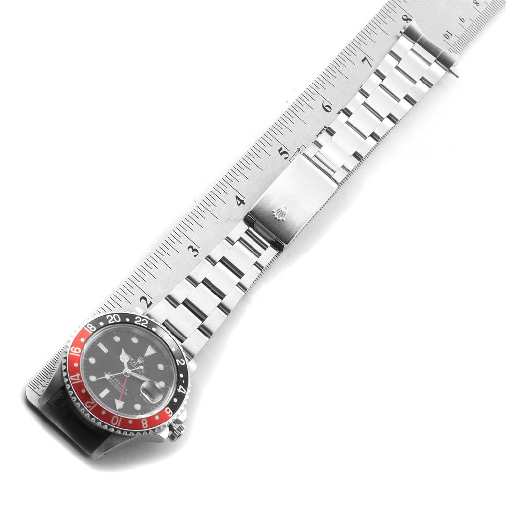 The image shows a top-down view of a Rolex GMT-Master 16760 Men's Stainless Steel Black Dial 16760 Men's Stainless Steel Black Dial watch laid flat along a ruler.