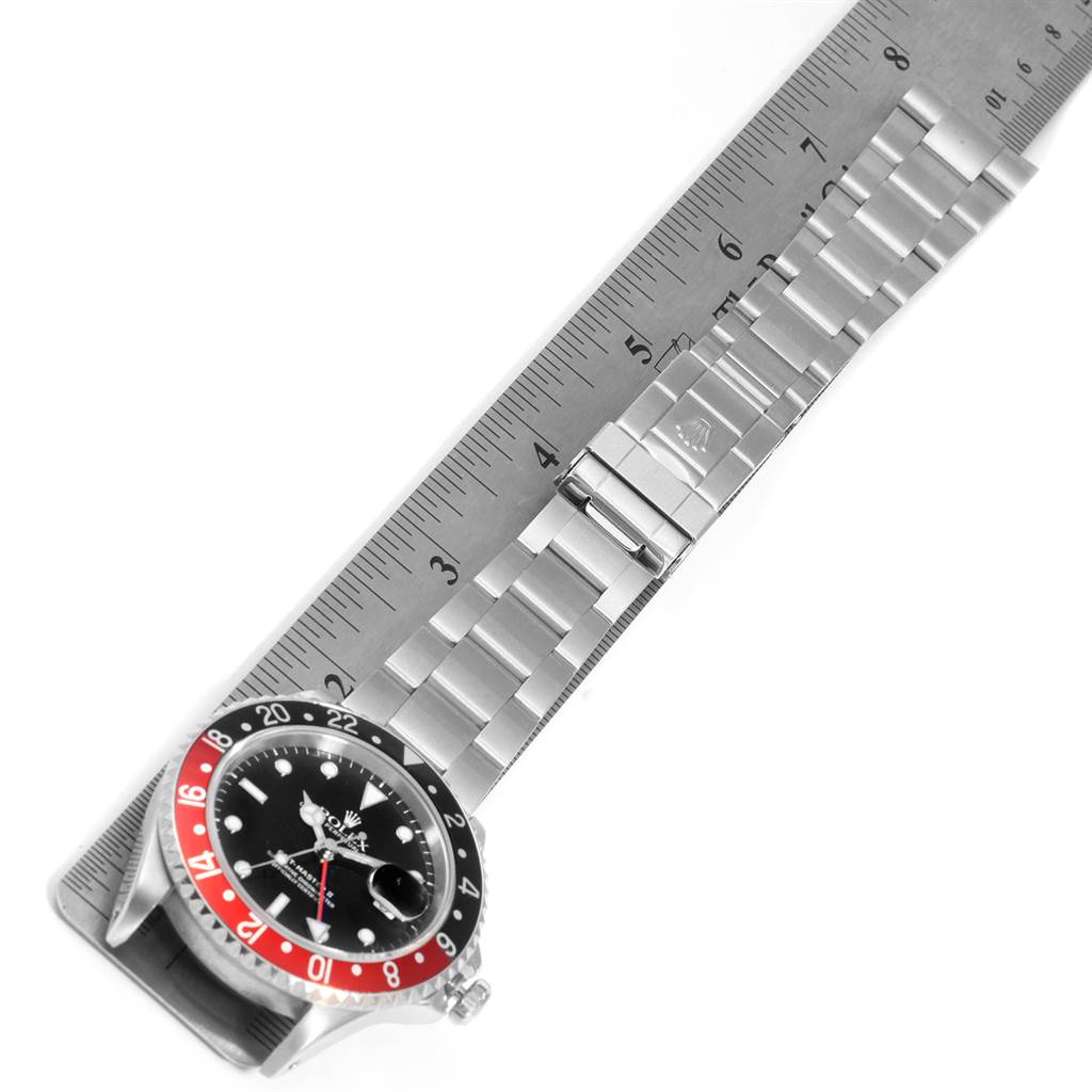 The image shows a Rolex GMT-Master 16710 Men's Stainless Steel Black Dial 16710 Men's Stainless Steel Black Dial watch laid flat with its bracelet and a ruler for measurement.