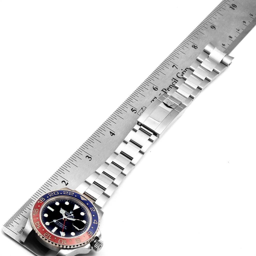 The image shows a Rolex GMT-Master 116719 Men's White Gold Black Dial 116719 Men's White Gold Black Dial watch laid flat with its strap extended and measured next to a ruler.