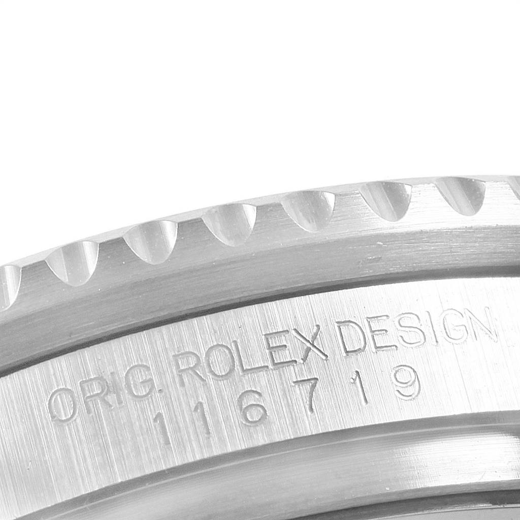 This image shows an angled close-up of the ridged bezel and case side of the Rolex GMT-Master 116719 Men's White Gold Black Dial 116719 Men's White Gold Black Dial, including the inscription with the model number.