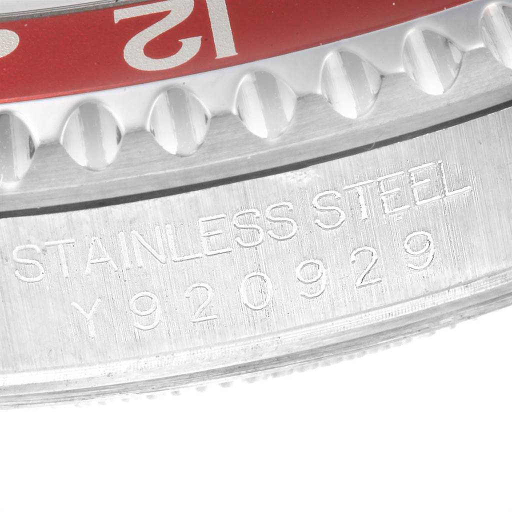 This close-up image displays the serial number and part of the bezel of a Rolex GMT-Master 16710 Men
s Stainless Steel Black Dial 16710 Men
s Stainless Steel Black Dial watch.