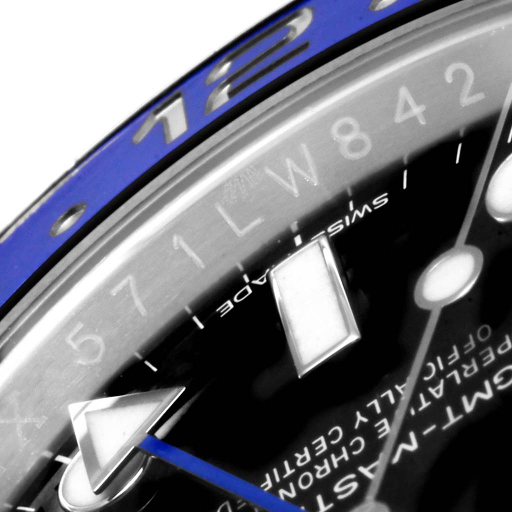 This close-up image of a Rolex GMT-Master 116710 Men's Stainless Steel Black Dial 116710 Men's Stainless Steel Black Dial watch shows the bezel with numbers, the hour markers, and the blue GMT hand.