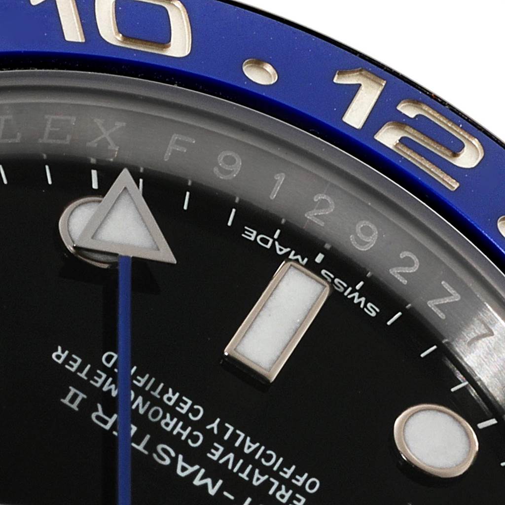 This close-up angle shows part of the dial and bezel of the Rolex GMT-Master 116710 Men's Stainless Steel Black Dial 116710 Men's Stainless Steel Black Dial watch.