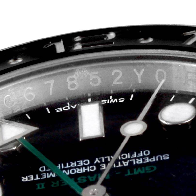 The image shows a close-up of the dial and part of the bezel of a Rolex GMT-Master 116710 Men's Stainless Steel Black Dial 116710 Men's Stainless Steel Black Dial watch, displaying hour markers and text.