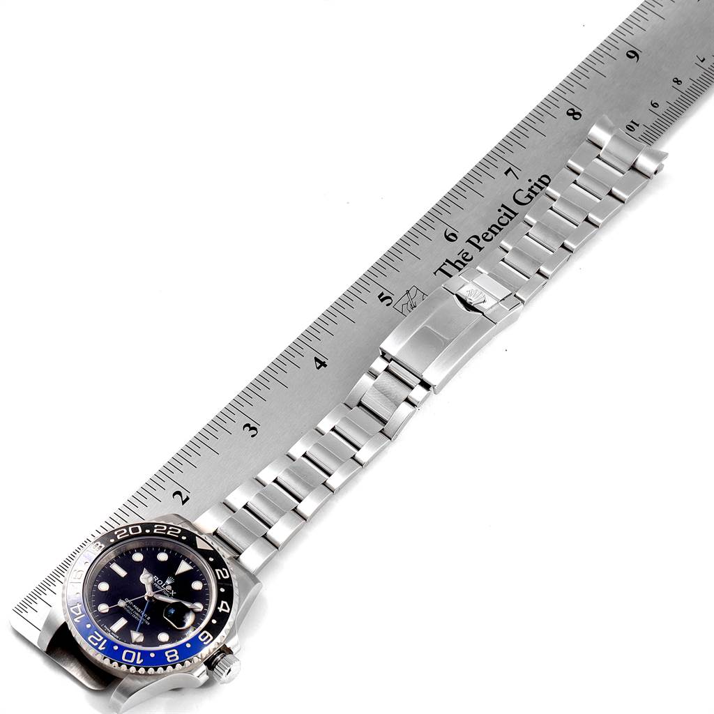 The image shows a Rolex GMT-Master 116710 Men's Stainless Steel Black Dial 116710 Men's Stainless Steel Black Dial watch placed next to a ruler, displaying the watch's face, bracelet, and clasp.