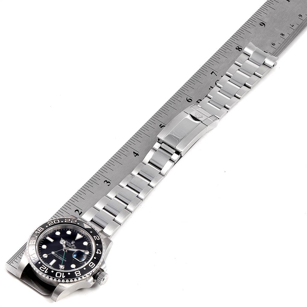 The image shows a Rolex GMT-Master 116710 Men's Stainless Steel Black Dial 116710 Men's Stainless Steel Black Dial watch laid flat, displaying the face, bezel, and full metal bracelet alongside a ruler.