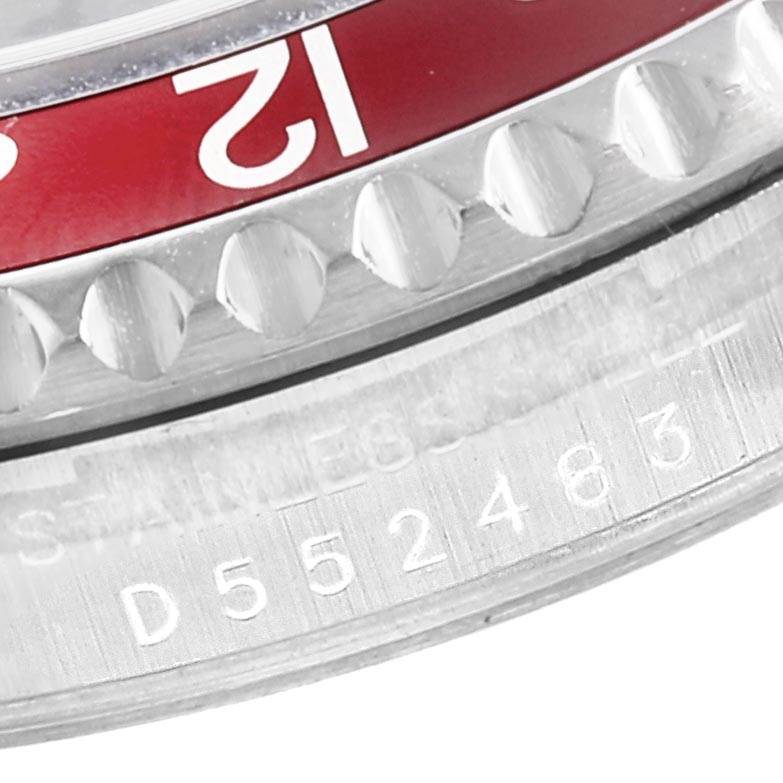 The image shows a close-up of the bezel and the engraved serial number of a Rolex GMT-Master 16710 Men's Stainless Steel Black Dial 16710 Men's Stainless Steel Black Dial watch.