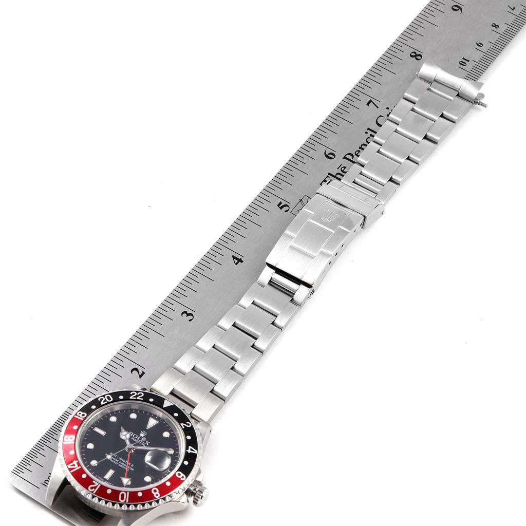 The image shows an overhead view of a Rolex GMT-Master 16710 Men's Stainless Steel Black Dial 16710 Men's Stainless Steel Black Dial watch partly extended, showcasing its dial, bezel, and bracelet.