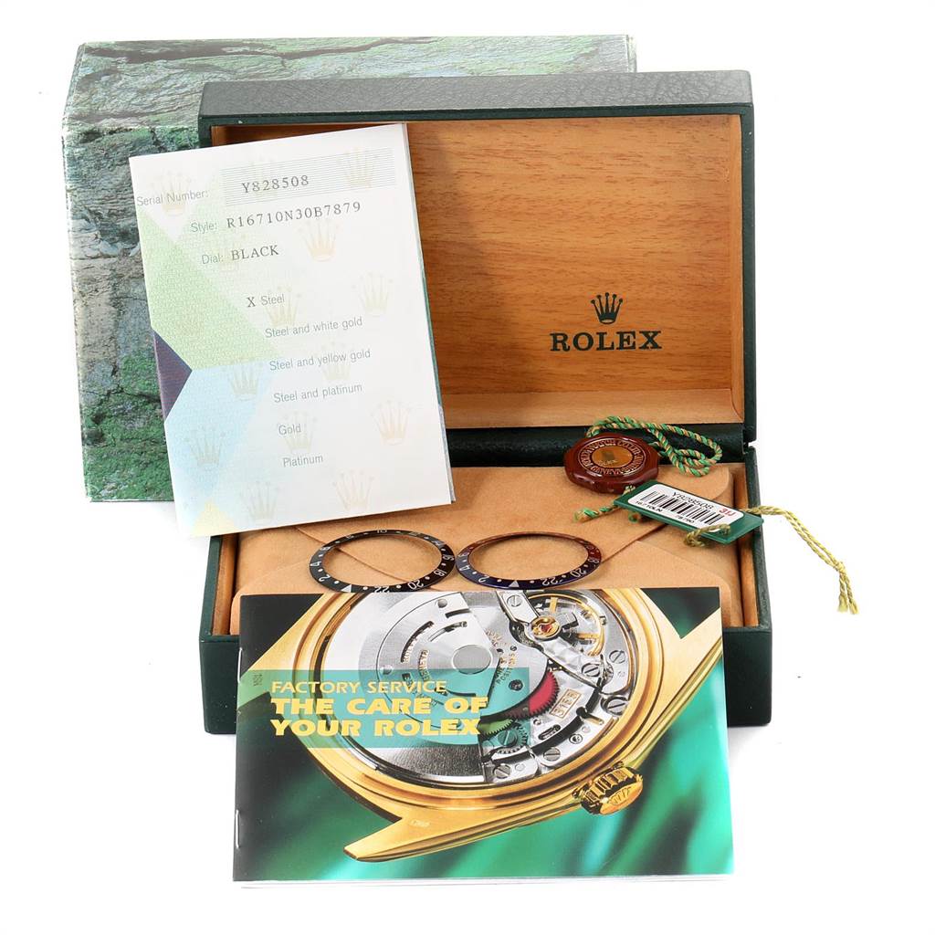 The image shows a Rolex GMT-Master 16710 Men's Stainless Steel Black Dial 16710 Men's Stainless Steel Black Dial watch box and accessories, including bezel inserts, tags, and manuals.